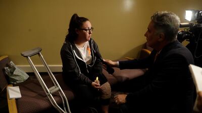 Dani Merrill, left, who survived both the Las Vegas concert shooting and the Thousand Oaks bar shooting conducts an interview during a vigil. AP Photo