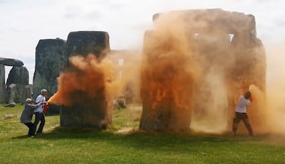 Activists spraying an orange powder at Stonehenge in Wiltshire, southwest England, on June 19. AFP