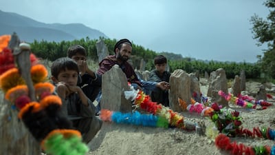 The families of Javari village have decorated the graves of the relatives with bright garlands.