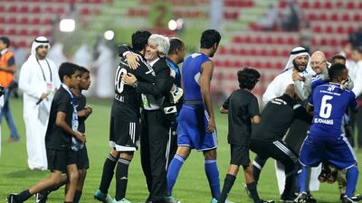 Al Nasr coach Ivan Jovanovic, centre, celebrates with his players after guiding his team to the Arabian Gulf Cup.