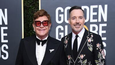 Elton John, wearing Gucci, and David Furnish arrive at the 77th annual Golden Globe Awards at the Beverly Hilton Hotel on January 5, 2020. AFP