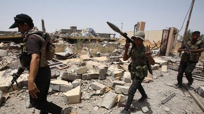 Iraqi Shiite fighters from the Popular Mobilisation Forces in the city of Baiji, north of Tikrit, as they fight alongside Iraqi forces against ISIL. Ahmad Al Rubaye/AFP Photo