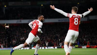 Arsenal's Alexandre Lacazette, left, celebrates his equaliser against Liverpool. Reuters