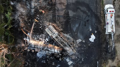 Firefighters in Hidalgo, Mexico, where several people died after a passenger truck collided with the trailer of a fuel truck. Reuters