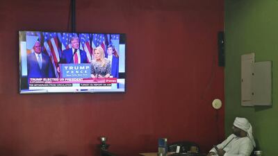 A Emirati man smokes a waterpipe while watching coverage of President-elect Donald Trump at a coffee shop in Dubai. Kamran Jebreili / AP Photo