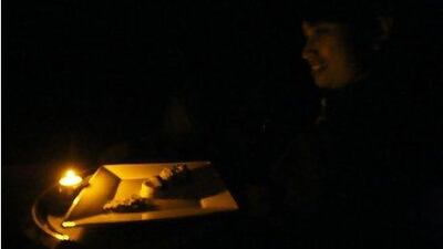 A waiter serves food in darkness. Pawan Singh / The National