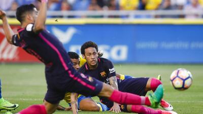 Barcelona’s Neymar, centre, watches the ball. Lucas de Leon / AP Photo