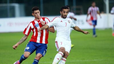 Paraguay's striker Tonny Sanabria tries to get past the UAE's Ali Mabkhout during their friendly at Villach, Austria, on September 7, 2014. DANIEL RAUNIG / AFP
