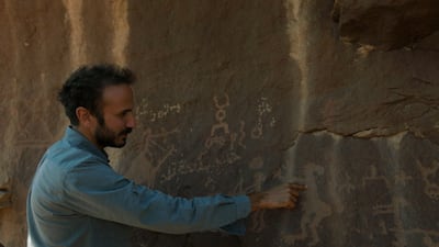 A scene from the documentary in which archaeologist Yan Axoy explores the city's rock art