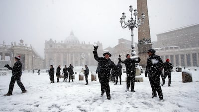 Shawn Roser, from Venice, Florida, a student at the North American college in Rome, throws a snowball as he plays in a snow blanketed St Peter's Square at the Vatican in Rome on February 26, 2018. Alessandra Tarantino / AP Photo