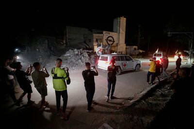 Vehicles of the International Committee of the Red Cross transporting remains of Israeli hostages handed over by Hamas. EPA