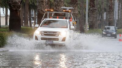 Vehicles navigate floodwater on Riverside Drive near the Swan River, which is partially closed due to storm flooding, in Perth, Western Australia. EPA