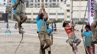 People pull themselves up on the ropes.