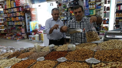 epa06933110 A shopper (R) weights Iranian pistachios at a popular market in Abu Dhabi, United Arab Emirates, 07 August 2018. The US sanctions were reimposed on some of Iranian products which came a step after US President Donald J. Trump has withdrawn from Iran nuclear deal, the US sanctions aiming to increase the pressure on Iranian economy. The ban is including the export of Iranian carpets and pistachios to the US. EPA/ALI HAIDER