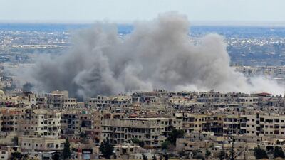 A general view taken from a government-held area in Damascus shows smoke rising from the rebel-held enclave of Eastern Ghouta on the outskirts of the Syrian capital following fresh air strikes and rocket fire, despite a UN ceasefire in place / AFP