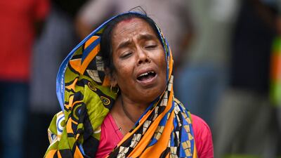 A victim's family member weeps at a business park used as a temporary mortuary to identify the dead. AFP