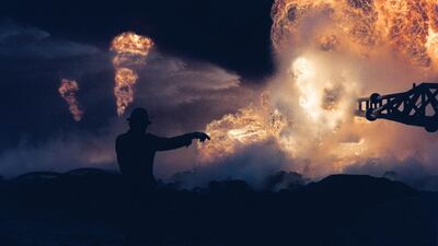 Fire fighters try to put out a blaze at a blown-out well damaged by retreating Iraqi soldiers in Al-Ahmadi oil field in southern Kuwait, April 1, 1991. AFP