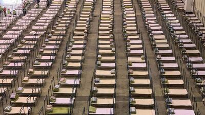 Workers set up beds at an exhibition centre that was converted into a hospital in Wuhan, in China's central Hubei province, the epicentre of virus outbreak. AFP