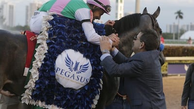 Jockey Mike Smith, atop Arrogate, is congratulated by assistant trainer Jim Barnes after riding Arrogate to victory in January’s Pegasus World Cup. Lynne Sladky / AP file