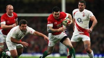 Stephen Jones of Wales breaks past Lee Mears of England.