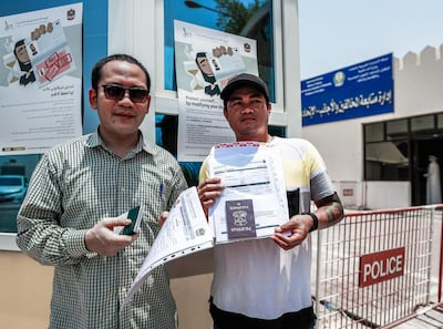 Rustono Drmo from Indonesia and Ryan Baliente apply for the visa amnesty scheme. Victor Besa / The National