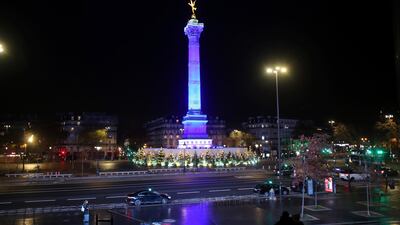 A couple is sitting on the steps of the Opera Bastille during a curfew, in Paris. France is implementing strict anti-virus measures, including a lockdown since October that was only partially lifted on Tuesday and now includes a curfew from 8 p.m. to 6 a.m. All restaurants and bars, tourist sites and many other public places remain closed. AP Photo