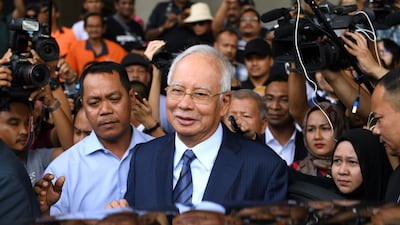 Former Malaysia's prime minister Najib Razak (C) leaves the courthouse in Kuala Lumpur after being charged. AFP