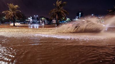 People drive cars on the flooded main road of the Daeya area of Kuwait city. AFP