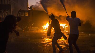 Protesters use fire extinguishers to block protesters' movements from the Internal Security Forces, not pictured, during a protest at Martyrs Square. Getty Images