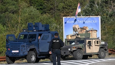 Armed Kosovan police officers secure a road near the village of Banjska. EPA