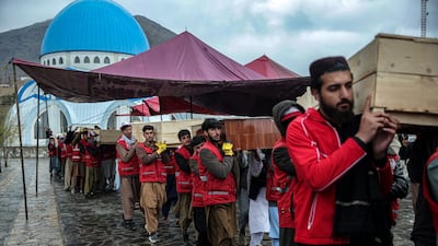 Afghan Red Crescent Society volunteers carry the coffins of those killed in an attack on Kabul. The Afghan Taliban government says a drug rehabilitation centre was hit. EPA