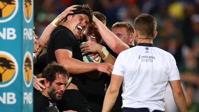 New Zealand's Scott Barrett celebrates with teammates after scoring their fourth try. Reuters