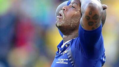 Djibril Cisse, the France striker, holds his head after the sending off of teammate Yoann Gourcuff.