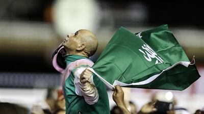 Mike Smith atop Arrogate celebrates winning the Dubai World Cup. Christopher Pike / The National