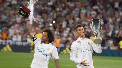 Real's Cristiano Ronaldo and Marcelo hold up the Uefa Super Cup and La Liga title for 2016-17. Getty