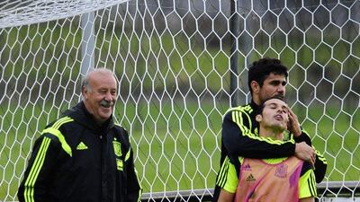 Spain coach Vicente del Bosque, left, smiles as Diego Costa, second left, who embraces Pedro Rodriguez during a training session at the Atletico Paranaense training center in Curitiba, Brazil, Sunday, June 15, 2014. AP Photo/Manu Fernandez