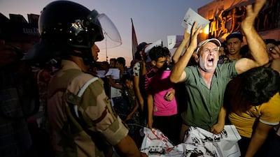 Iraqi protesters chant slogans demanding services and jobs during a demonstration in Tahrir Square, Baghdad, Iraq. AP Photo
