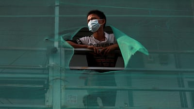 Myanmar migrant worker Chit Kaung, 21, looks from his dormitory room, in which he has been stuck for 12 days owing to lockdown measures after more than a thousand Covid-19 cases were detected in his accommodation in Bangkok, Thailand. Reuters