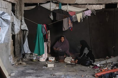 Palestinian women prepare food inside a damaged building at the Jabalia refugee camp in the northern Gaza Strip on October 5. AFP
