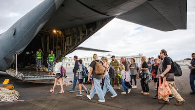 Tourists board an Australian military plane as part of an evacuation process in Noumea, New Caledonia, where rioting has spread. AP