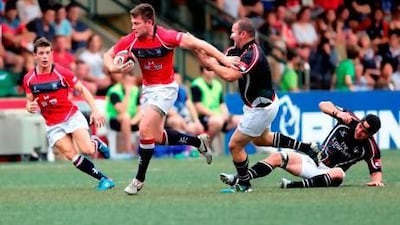 UAE captain Brett Williams attempts to get to grips with the Hong Kong captain Tom McColl, as a grounded Jamie Clarke looks on. Courtesy of Elite Step