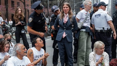 US activist and whistleblower Chelsea Manning, centre, is arrested at a protest against the war in the Middle East, outside the offices of US Senator Charles Schumer in New York. EPA