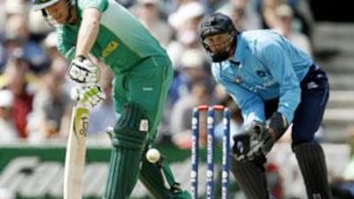 AB de Villiers of South Africa plays an on-drive, watched by Colin Smith of Scotland, at the Oval in London.