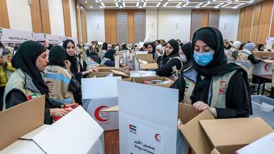 Workers with the Emirates Red Crescent Bridges of Goodness campaign prepare aid for earthquake-ravaged Turkey and Syria at Adnec in Abu Dhabi. Victor Besa / The National