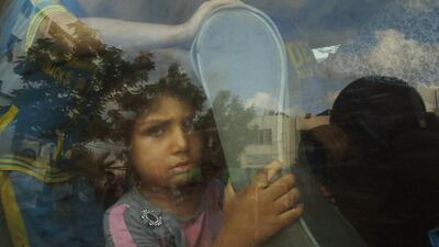 A Palestinian girl sits in a minibus after fleeing her family’s house during heavy Israeli shelling, in Gaza City. Suhaib Salem / Reuters