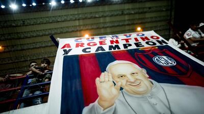 A banner with an image of Pope Francis and a message that reads in Spanish: “Cuervo, Argentine and Champion,” during a national football league match between San Lorenzo and Colon de Santa Fe in Buenos Aires, Argentina, Natacha Pisarenko / AP Photo / March 15, 2014.