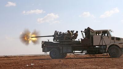 Fighters from the Free Syrian Army fire an anti-aircraft machine gun mounted on a vehicle during fighting against the Islamic State (IS) in the northern Syrian village of Yahmoul in the Marj Dabiq area north of Aleppo. Nazeer al-Khatib / AFP