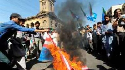 Pakistani students burn US flags during a rally in Karachi to denounce US air strikes in Pakistan tribal areas.