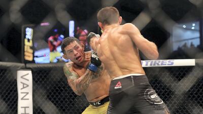 Abu Dhabi, United Arab Emirates - September 07, 2019: Lightweight bout between Mairbek Taisumov and Diego Ferreira (yellow shorts, winner) in the Main card at UFC 242. Saturday the 7th of September 2019. Yas Island, Abu Dhabi. Chris Whiteoak / The National