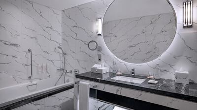 Sleek marble bathrooms with walk-in showers